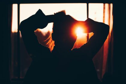 silhouette of woman holding hair