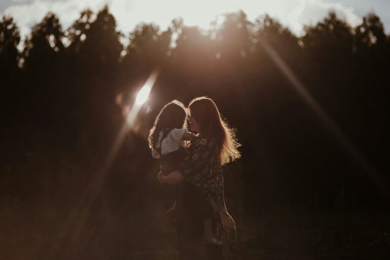 a woman holding a baby in her arms